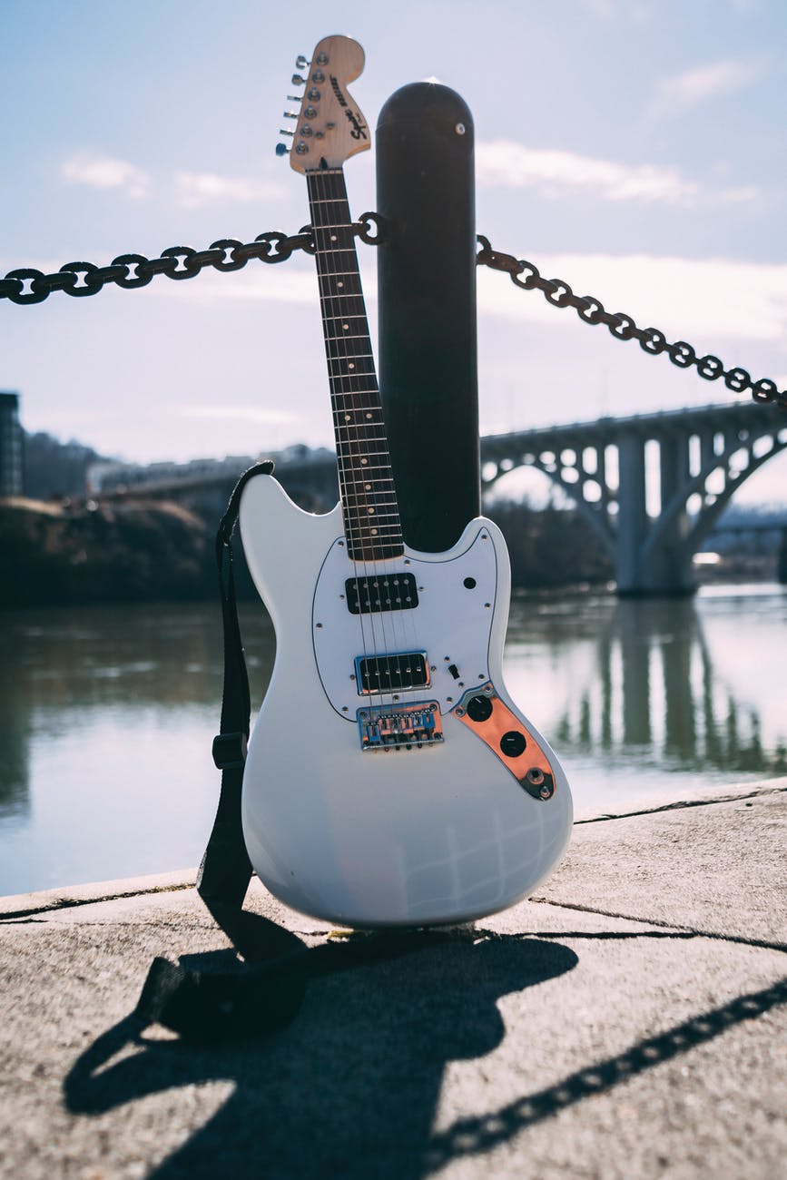 photo of guitar near river
